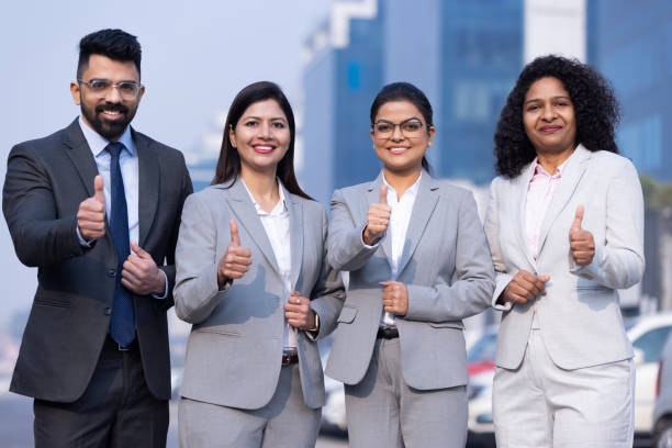 Group of successful business people showing thumbs up.